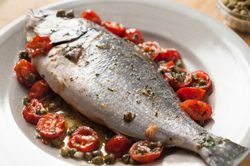 Dorada fish with cherry tomatoes in the oven