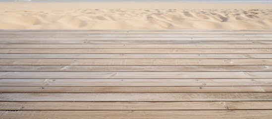 Copy space image of a textured boardwalk covered in sand providing a closeup view of the sandy wood planks in a pattern
