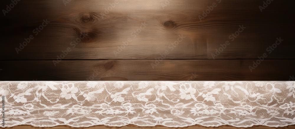 Poster view of a wooden table with white lace providing a clear space for text in the image. copy space ima