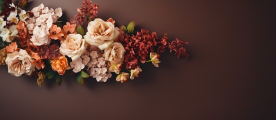 An aesthetically pleasing flat lay arrangement of beautiful flowers on a brown background The bouquet is positioned from a top view allowing for an overhead perspective with an empty space for a copi