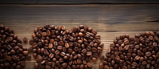 A heart shaped arrangement of coffee beans on a rustic wooden surface creating a visually pleasing copy space image - Powered by Adobe