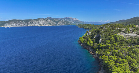 AERIAL: Flying alongside rugged rocky seafront of the Adriatic island of Korcula