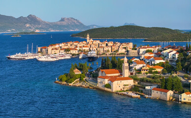 AERIAL: Scenic shot of the picturesque town of Korcula on a sunny summer day.
