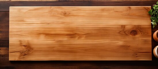A top down view of a kitchen table with an empty wooden cutting board offering plenty of copy space for images