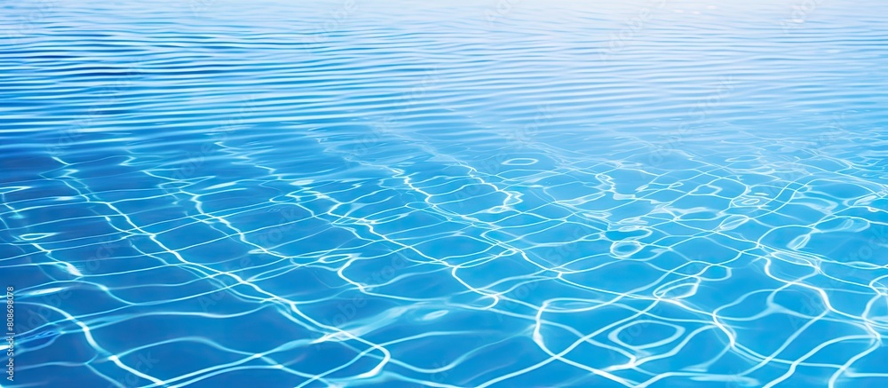 Poster a serene image of a swimming pool shines with vibrant blue tiles while gentle ripples on the water c