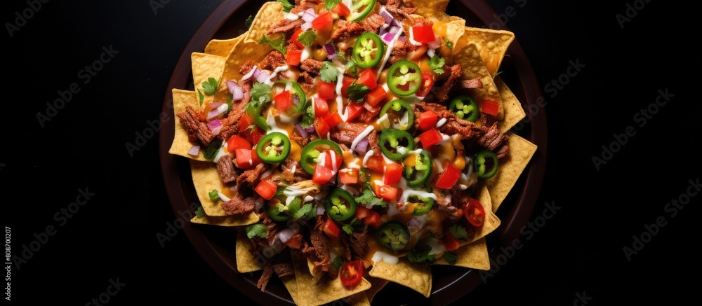 Poster an overhead shot of nachos a delicious mexican dish made from tortilla chips beef and fresh vegetabl