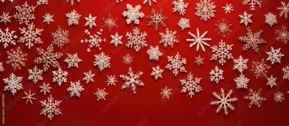 Poster a top down view of christmas snowflakes on a red knitted background with ample space for additional 