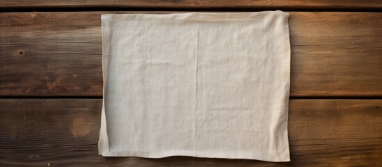 Copy space image of a napkin placed on a vacant weathered wooden surface with a view from above