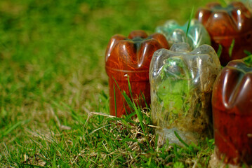 Fence for a flower bed made of plastic bottles in the garden