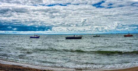 fishing boats anchored at the shore, uk Bedford seashore background