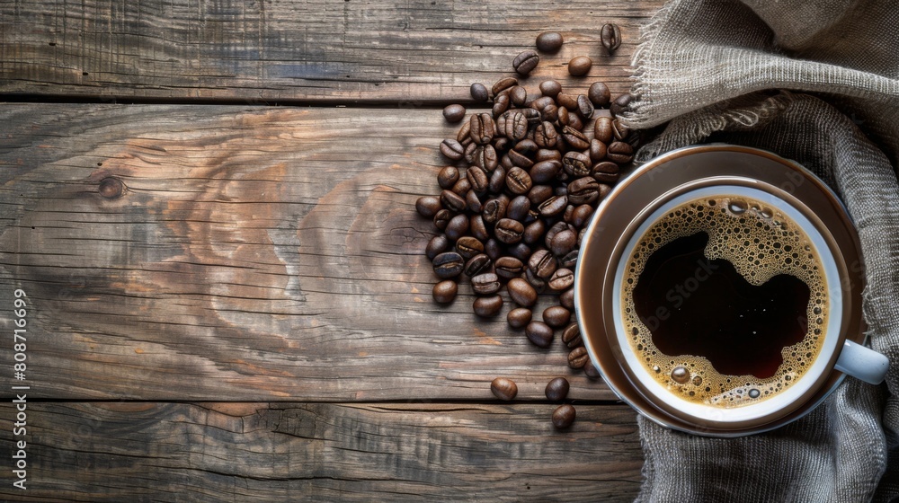Poster coffee cup and beans on old wood background selective focus. Top view with copy space for your text
