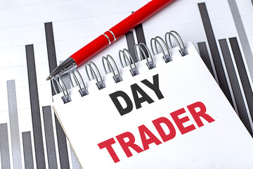 DAY TRADER text on notebook on chart with pen