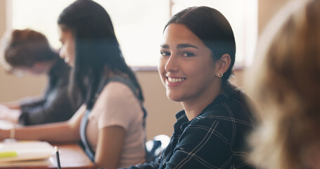 High school, student and portrait in classroom for education course with knowledge, academic or scholarship. Girl, desk and face at learning academy on campus for future studying, lecture or happy