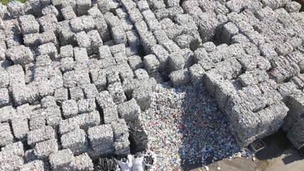 Aerial view overlooking large garbage cubes, sunny day at a junkyard