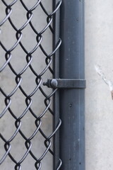 Close-up of metal fence against concrete wall