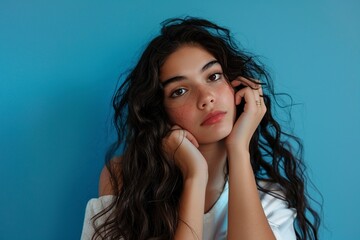 Woman Leaning Against Blue Wall