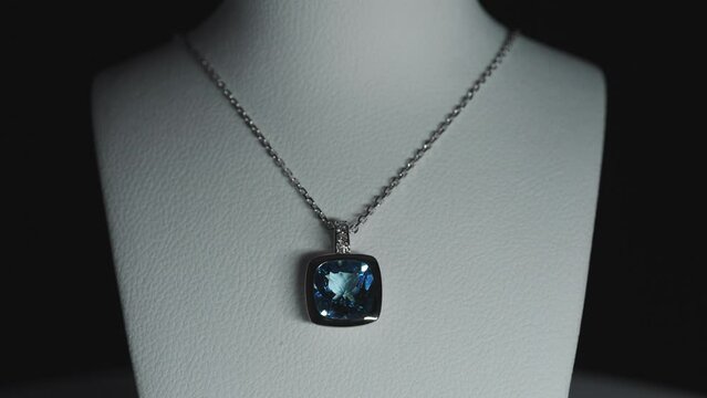 Blue gemstone on a necklace on a bust