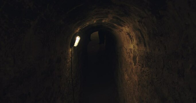 Beautiful shot of wine bottles stacked in a subway container in Burgos, Spain with low light in tunel