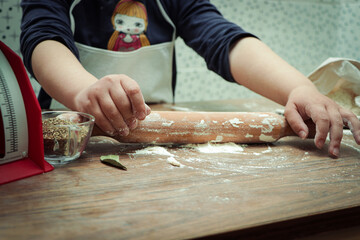 Hands-On Fun: Little Girl Rolling Out Pizza Dough with a Rolling Pin