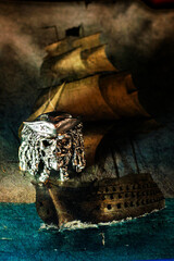 Ring with the face of a pirate on the background of the page with a pirate ship	
