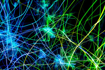 Intense neon lines intertwined in electric green and blue hues. Striking image on black background.