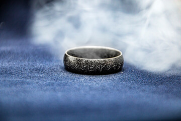 A rune-engraved ring is shrouded in gray smoke	
