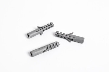 Grey plastic dowels for screws on a white isolated background