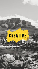 This captivating black and white photograph showcases the stunning mountains against a backdrop of a serene beach. Overlaying the image is bold yellow text that reads "CREATIVE" adding a vibrancy