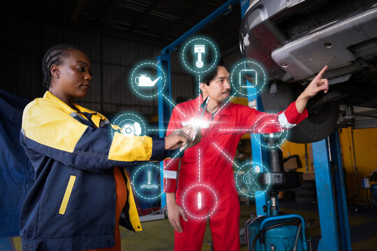 Car mechanic inspects car using technology and computer show resault at virtual screen.