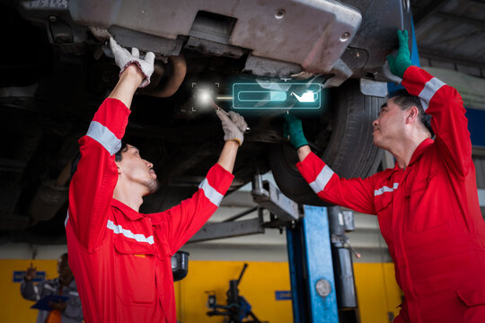 Car mechanic inspects car using technology and computer show resault at virtual screen.