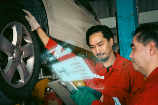 Car mechanic inspects car using technology and computer show resault at virtual screen.