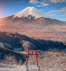 Red Japanese Torii pole, Fuji mountain and snow in Kawaguchiko, Japan. Forest trees nature...