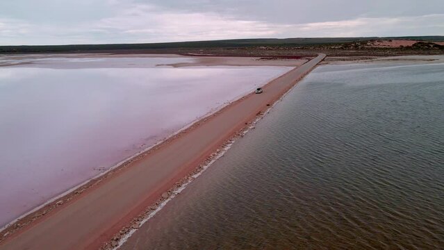 Point Sinclair Road And Pink Lake By Lake Macdonnell In Daytime In Penong, South Australia. - aerial shot
