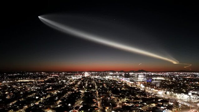 Aerial footage of a rocket crossing the dark dusk sky over Hermosillo city, Sonora, Mexico