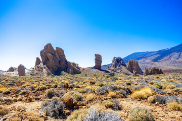 scenic volcanic mountain scenery with unique rock formations on a sunny day with blue sky and...