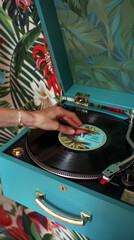 A person is putting a record on a turntable