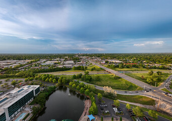 A distant aerial view of downtown Lexington, KY, from the intersection of New Circle Road and Nicholasville Road, showcases the pond of the Lexington Green shopping and entertainment complex