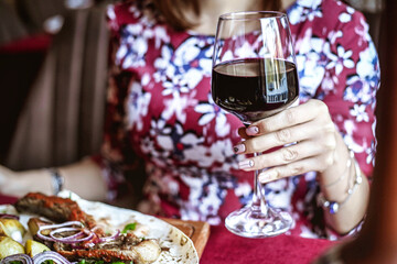 Woman Enjoying a Meal With Wine at a Table