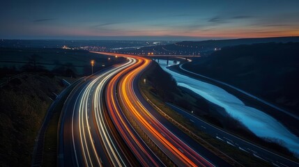 Fototapeta premium A long exposure photo of the lights from cars on a motorway at night