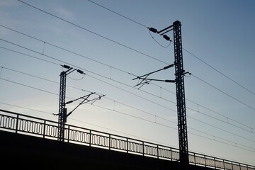 High voltage electrical wires over empty train tracks. High voltage tower and railway. Train tracks...
