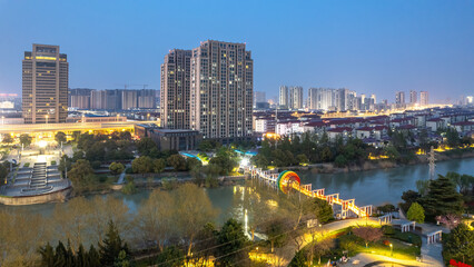 Dazzling Cityscape at Dusk with Glowing Urban Park