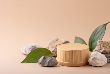 Natural Podium for Display Packaging: podium made from bamboo wood, with a sleek and modern design surrounded by leaves and rocks.