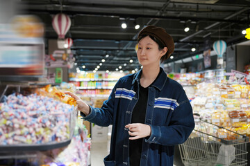 Young Shopper Selecting Products at Supermarket