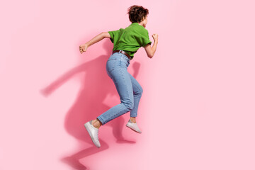 Full length profile rear photo of carefree person jumping running empty space isolated on pink...