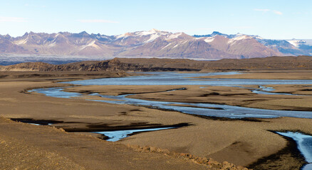 A desert landscape with a river running through it