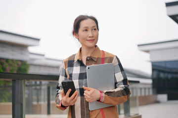 Confident Businesswoman with Tablet and Smartphone
