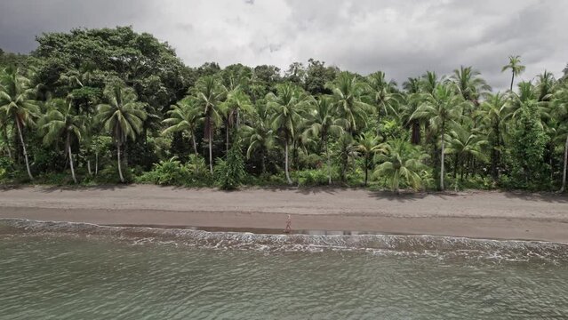 Tourist walking alone on an idyllic paradise beach