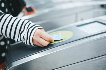 Passenger Using Contactless Payment at Subway Turnstile