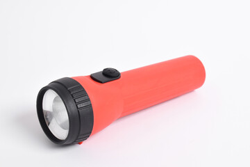 Red color flashlight isolated on white background. Red Battery-powered flashlight