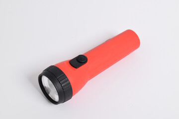 Red color flashlight isolated on white background. Red Battery-powered flashlight